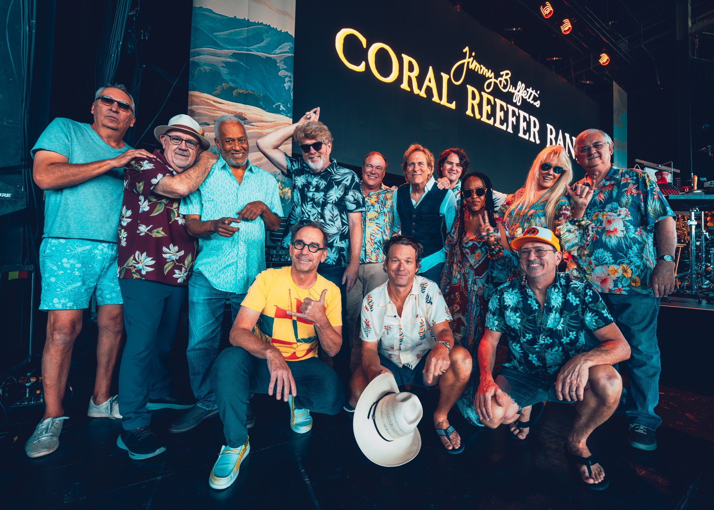 The Coral Reefer Band posing in front of a 'Coral Reefer Band' sign.
